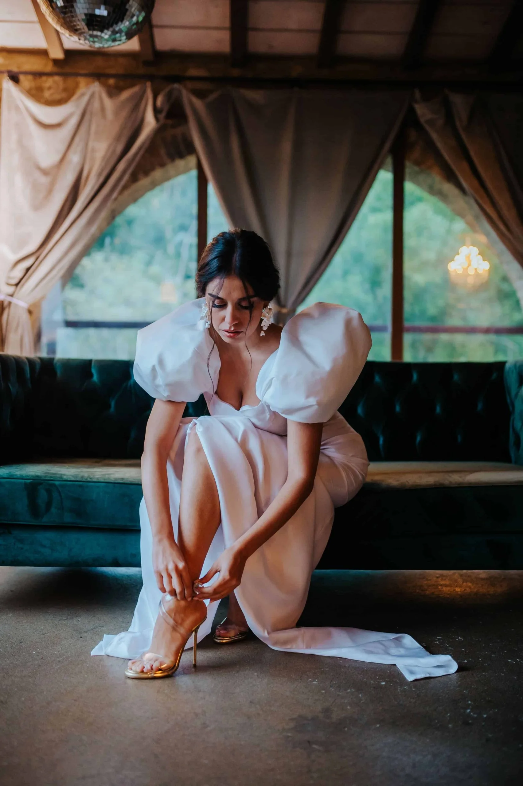 Bride getting ready by tying her shoes